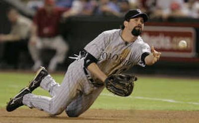 Rockies' Todd Helton tosses the ball to first for out Friday. Associated Press
(Associated Press / The Spokesman-Review)