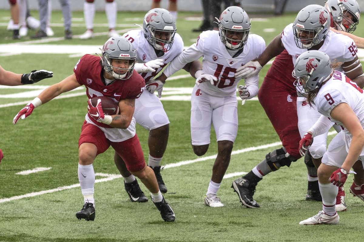 Washington State running back Kannon Katzer., left, carries the ball in the second quarter of the annual Crimson and Gray scrimmage on Saturday, April 24, 2021, at Martin Stadium in Pullman, Wash.  (Geoff Crimmins/For the Spokesman-Review)