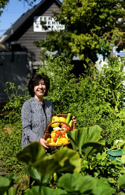 Fery Haghighi of Fery’s Catering & Takeout stands in the garden behind her catering business on Spokane’s lower South Hill.  (Kathy Plonka / The Spokesman-Review)