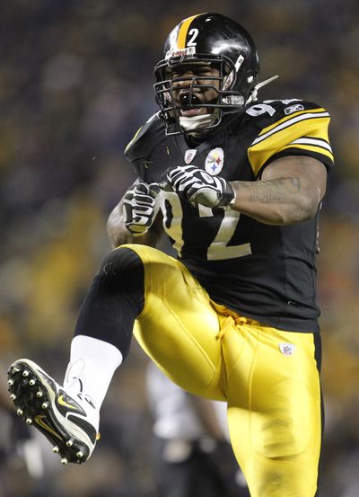 Pittsburgh Steelers linebacker James Harrison kicks up his heels after sacking Joe Flacco.  (Associated Press)