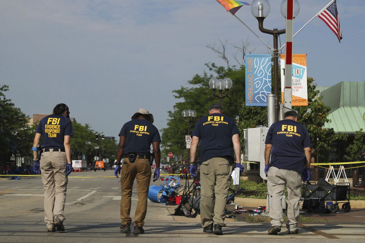 FBI search for evidence along Central Avenue a day after the Fourth of July mass in Highland Park, Illinois. (Stacey Wescott/Chicago Tribune/TNS)
