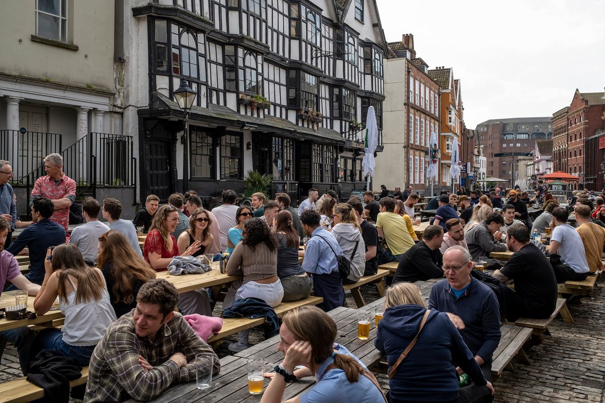 Pub patrons drinking outdoors in Bristol, England, on Saturday, April 29, 2023. The divide in Bristol goes a long way toward explaining the substantial split in public opinion about the role the royals play in a modern Britain.    (Andrew Testa/The New York Times)