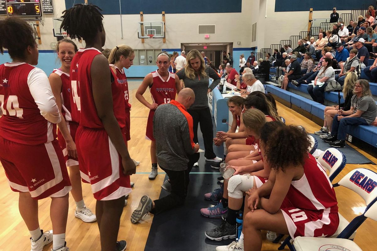 Coach Marc Allert (Post Falls), kneeling, gives instructions to his Region All-Star team. Metro defeated Region 87-80 at Central Valley HS on Wednesday, May 30, 2018. (Dave Nichols / The Spokesman-Review)