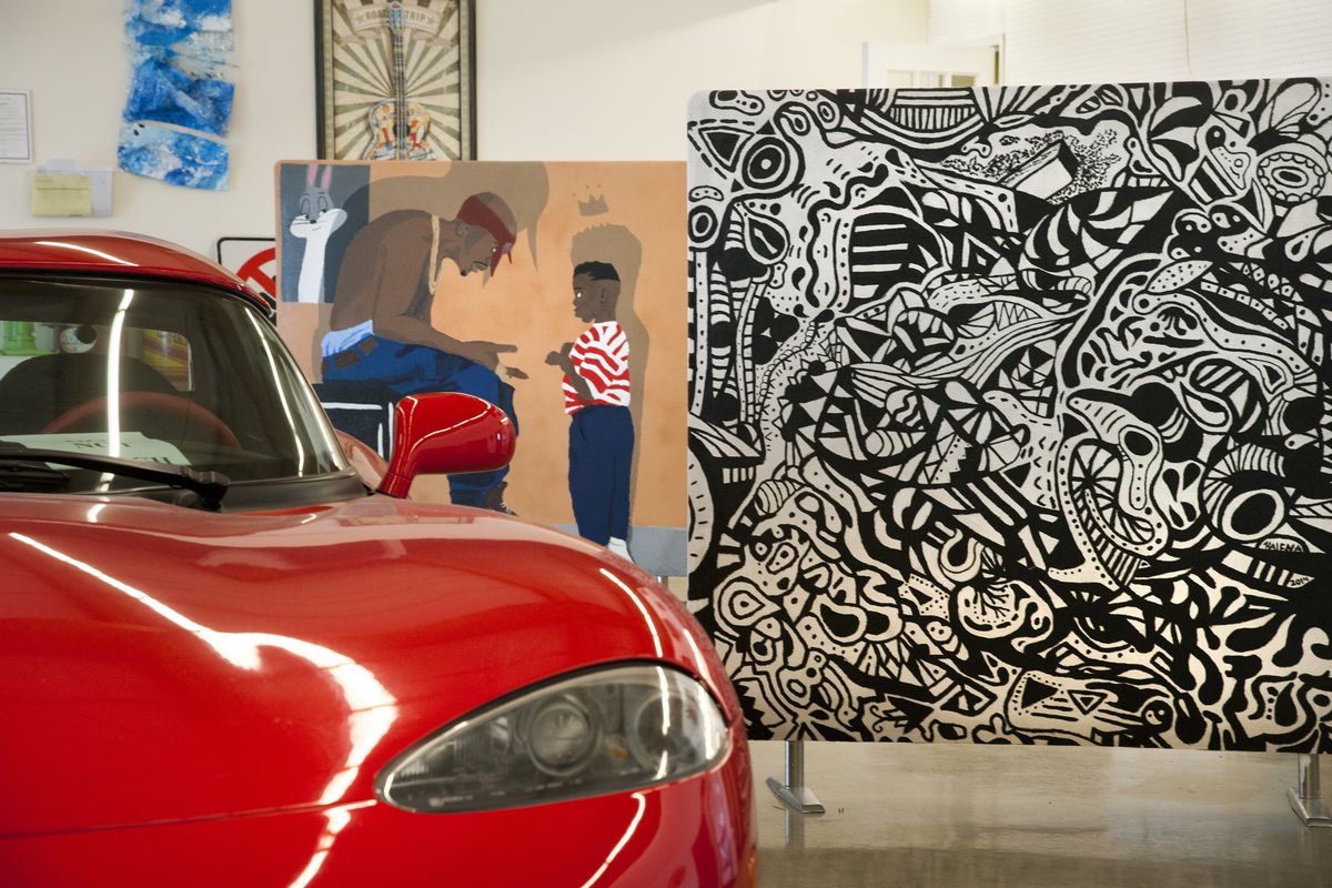 Works by Barker High School art students are shown on display next to a Dodge Viper at Arrotta’s Automax at Division Street and Lyons Avenue in north Spokane. (Dan Pelle)