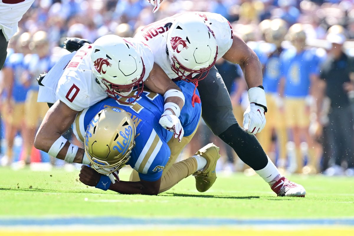 Washington State defensive back Sam Lockett III (0) and defensive end Brennan Jackson (80) sack UCLA Bruins quarterback Dante Moore (3) during the first half of a college football game on Saturday, Oct. 7, 2023, at Rose Bowl Stadium in Pasadena, Calif.  (Tyler Tjomsland/The Spokesman-Review)
