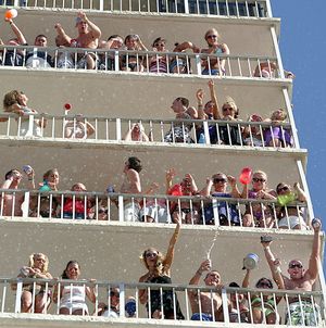 ORG XMIT: FLPAN101 Spring Break attendees dump beer and other drinks at people below while watching country music singer Kenny Chesney's concert from the upper floors of the  Summit Condominiums in Panama City Beach, Fla., on  Wednesday, March 11, 2009. (AP Photo/The News Herald, Terry Barner) ** MAGS OUT TV OUT COMMERCIAL ONLINE OUT  MANDATORY CREDIT ** (Terry Barner / The Spokesman-Review)