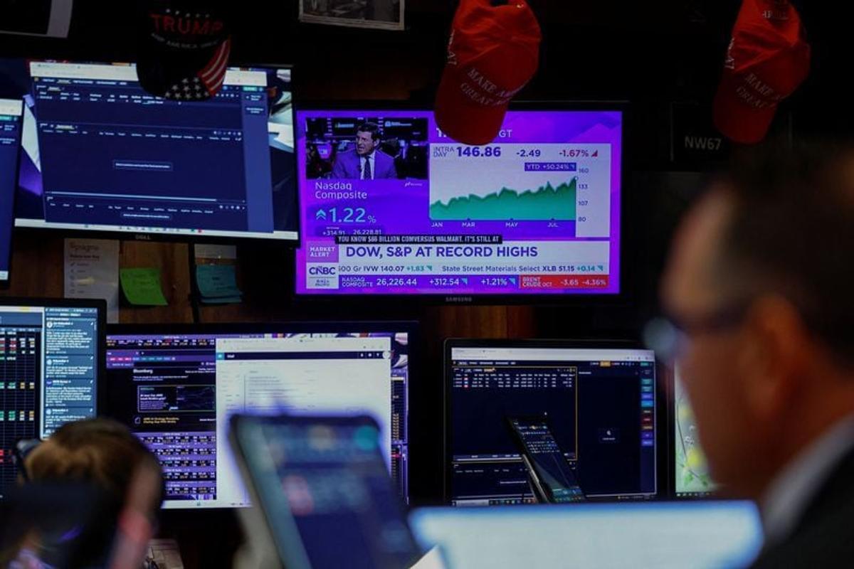 A screen displays stock market index data as traders work on the floor at the New York Stock Exchange (NYSE) in New York City, U.S., August 4, 2026.   (Jeenah Moon/Reuters)