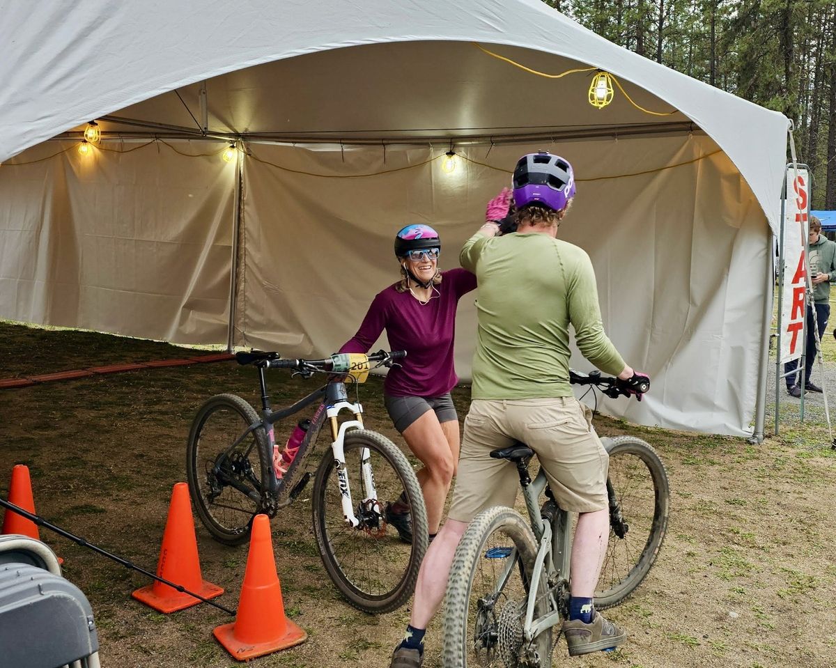 The author high-fives a handoff to teammate Mac Hollan at the 24 Hours of Riverside mountain bike race.  (Courtesy of Leo Schmeltzer)