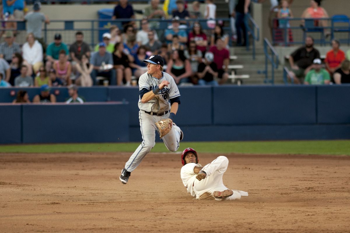 The Hops’ Nate Robertson and the Indians’ Eduard Pinto watch Robertson’s throw to first to complete a double play. (TYLER TJOMSLAND PHOTOS)