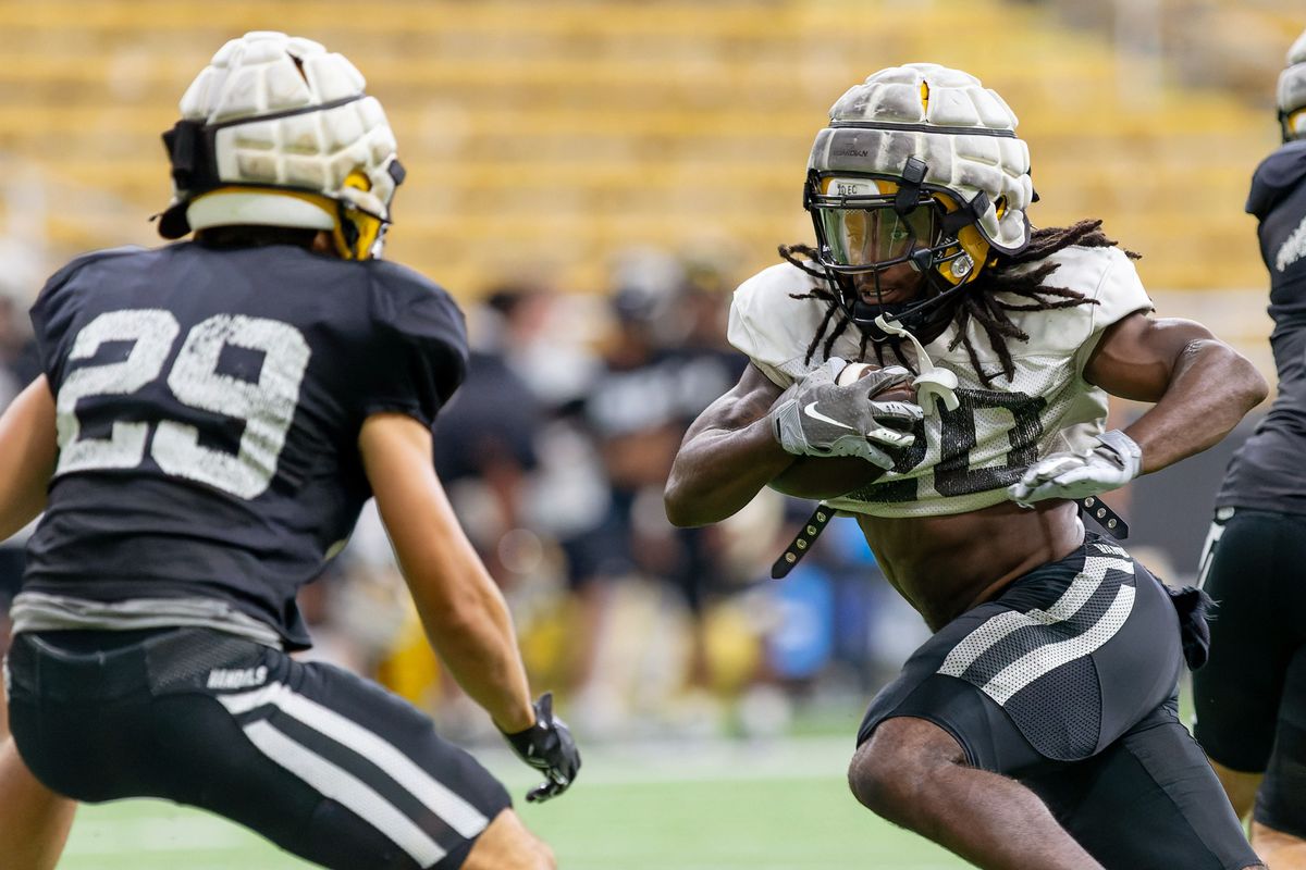 Idaho running back Elisha Cummings, right, looks for a way around defensive back Brayden Rice during an August scrimmage at the Kibbie Dome in Moscow.  (Geoff Crimmins/For The Spokesman-Review)