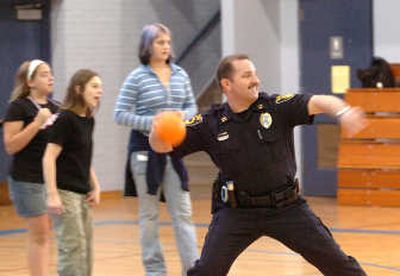 
Coeur d'Alene police Capt. Steve Childers plays dodgeball with children Wednesday at the afternoon program put on in part by  the Boys & Girls Club at Lakes Middle School. 
 (Jesse Tinsley / The Spokesman-Review)