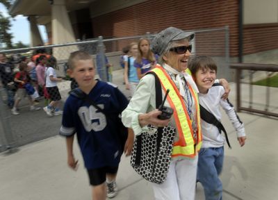 “Grandma Gene” Gorley hugs   Davyd Foster as she leads him and fellow McDonald Elementary School third-grader Johny Sherill to the buses after school Tuesday. The 83-year-old is retiring as a playground aide after working in the district for more than 40 years. (J. Bart Rayniak / The Spokesman-Review)