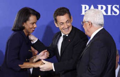 
Palestinian President Mahmoud Abbas, right, French President Nicolas Sarkozy and U.S Secretary of State Condoleezza Rice greet one another at the start of a donors conference Monday in Paris. Associated Press
 (Associated Press / The Spokesman-Review)