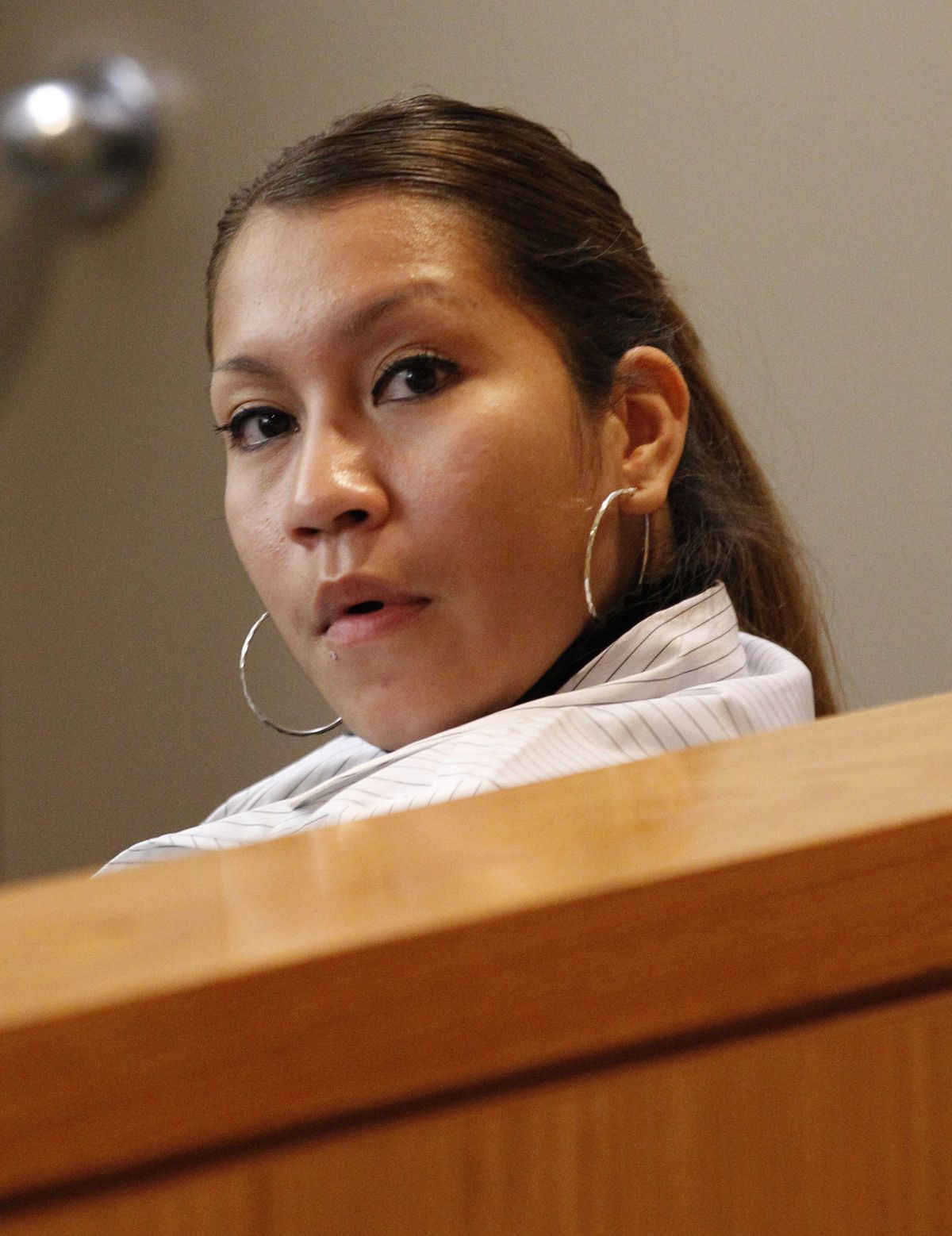Elizabeth Escalona, 23, sits in a courtroom to be sentenced, in Dallas, Monday, Oct. 8, 2012. Escalona pleaded guilty on July 12, 2012, to injury to a child and is facing up to life in prison.  A doctor has testified that the Texas mother glued her 2-year-old daughter