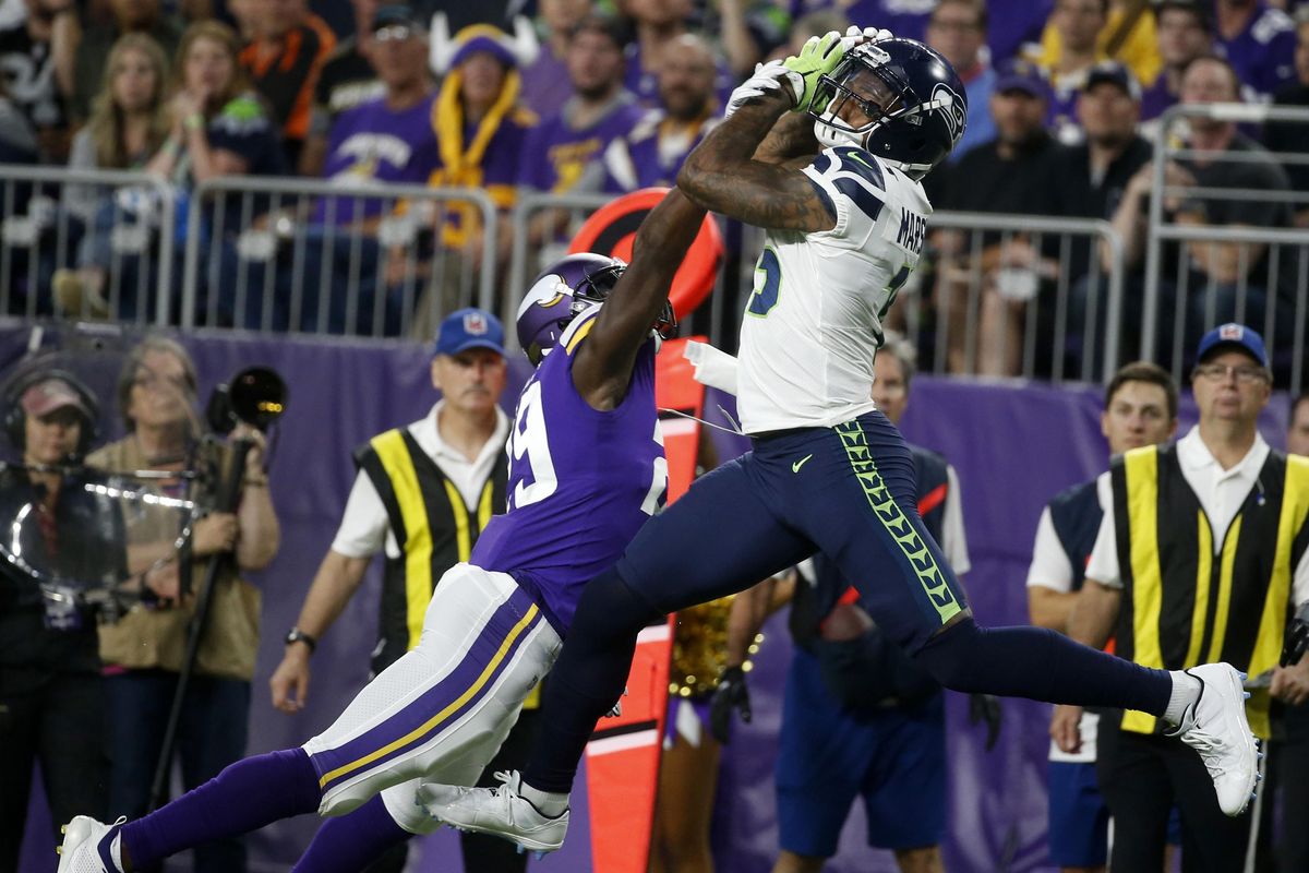 Seattle Seahawks wide receiver Brandon Marshall catches a pass over Minnesota Vikings defensive back Xavier Rhodes during the first half of Friday’s NFL preseason game in Minneapolis. (Bruce Kluckhohn / AP)