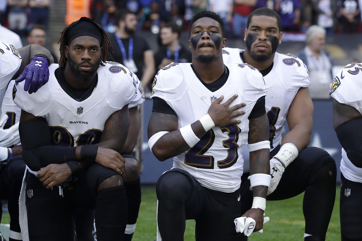 Baltimore Ravens strong safety Tony Jefferson (23) and Baltimore Ravens outside linebacker Matt Judon, left, kneel down with teammates during the playing of the U.S. national anthem before an NFL football game against the Jacksonville Jaguars at Wembley Stadium in London, Sunday Sept. 24, 2017. (Matt Dunham / Associated Press)