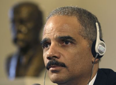Attorney General Eric Holder looks upon a press conference after a meeting in Prague, Czech Republic, Tuesday. (Associated Press / The Spokesman-Review)