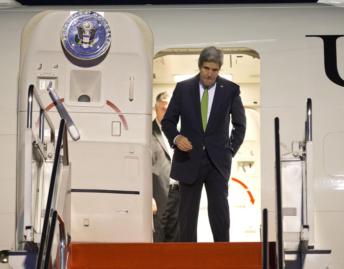 Secretary of State John Kerry steps off his plane after arriving at Halim Air Field on Saturday, Feb. 15, 2014, in Jakarta, Indonesia. (Evan Vucci / Pool Ap)