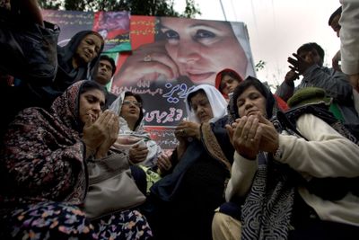 Supporters of former Prime Minister Benazir Bhutto pray Saturday at the site where she was assassinated in Rawalpindi, Pakistan.  (Associated Press / The Spokesman-Review)