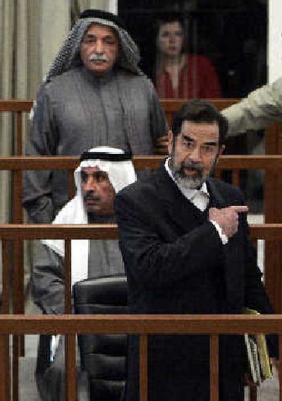 
Saddam Hussein argues with chief judge Raouf Abdel-Rahman after his half brother, Barzan Ibrahim Tikriti was forcibly removed from the trial Sunday. 
 (Associated Press / The Spokesman-Review)