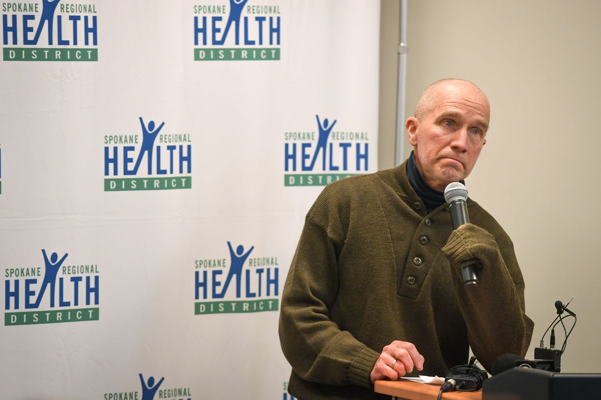 Spokane Regional Health District Health Officer Dr. Bob Lutz uses his sweater sleeve to hold the microphone on March 16 during a COVID-19 update press conference at the Spokane Regional Health District building.  (DAN PELLE)
