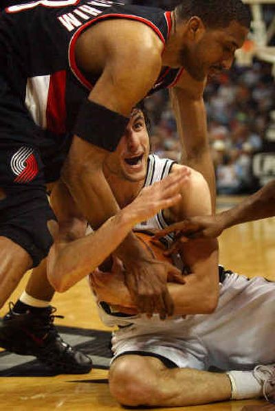Portland's Shareef Abdur-Rahim, top, tries to yank the ball away from San Antonio's Manu Ginobili on Tuesday. .
(Associated Press / The Spokesman-Review)