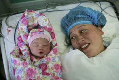 
Earthquake survivor Zhang Xiaoyan looks at her newborn baby girl at a hospital in Urumqi, in China's western Xinjiang region, Wednesday. Zhang was rescued on May 14.Associated Press
 (Associated Press / The Spokesman-Review)