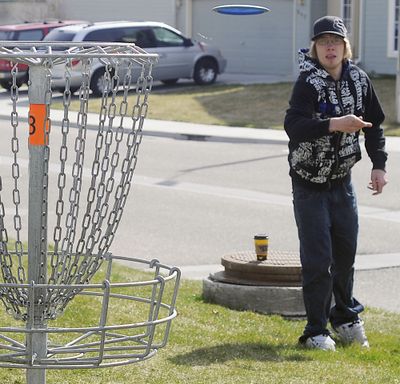 Talon Brim of Nampa, Idaho celebrates his birthday and the first day of spring by playing a game of frisbee golf with his girlfriend Saturday March 20, 2010 morning at West Park in Nampa, Idaho. (Mike Vogt / Idaho Press-tribune)