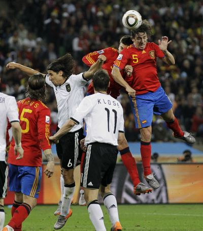 Spain's Carles Puyol, right, heads the ball to score a goal during the World Cup semifinal soccer match between  Germany and Spain at the stadium in Durban, South Africa, Wednesday, July 7, 2010. (Matt Dunham / Associated Press)