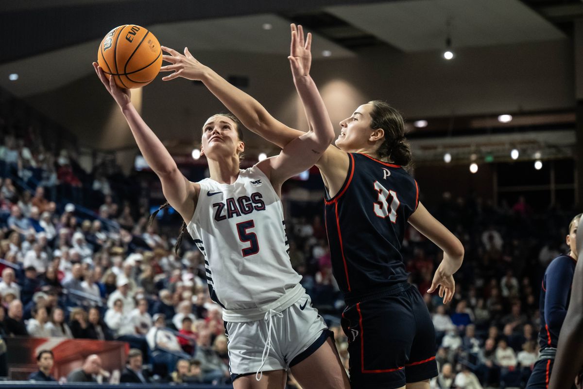 Gonzaga forward Maud Huijbens (5) lays the ball up as Pepperdine forward Megan Harkey (31) defends during the first half of a NCAA college basketball game, Thursday, Feb. 8, 2024, in the McCarthey Athletic Center.  (COLIN MULVANY)