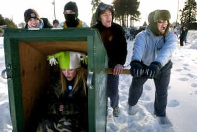 
Little Willy's team members, from left, Nick Kincaid, Aaron Bly, Josh Whitney and Andy Weil, get ready to push 12-year-old Chelsea Jansen in an outhouse on skis during the outhouse races at Winterfest 2005 in Deer Park on Saturday. Although Winterfest's snow softball games were canceled, residents braved frigid weather to come out for some of the other activities. 
 (Holly Pickett / The Spokesman-Review)