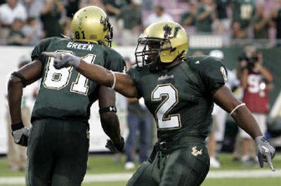 
South Florida running back Andre Hall, right, celebrates after scoring a 1-yard touchdown on the Bulls' third offensive play as teammate S.J. Green leaves the field. 
 (Associated Press / The Spokesman-Review)