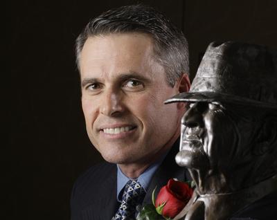 NCAA football coach Chris Peterson, of Boise State, poses with the Bear Bryant trophy Thursday, Jan. 14, 2010  in Houston. Petersen won the Paul 