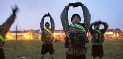 
Soldiers at Fort Lewis, Wash., stretch after their early morning run and calisthenics routine recently. Associated Press
 (Associated Press / The Spokesman-Review)