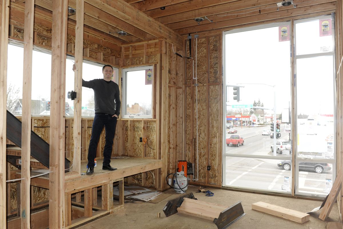 Evan Verduin stands in one of the town houses he is building on the corner of East Indiana Avenue and North Hamilton Street. Verduin is designing the units, which look out on the Gonzaga University neighborhood, with students or young professionals in mind. (Jesse Tinsley)