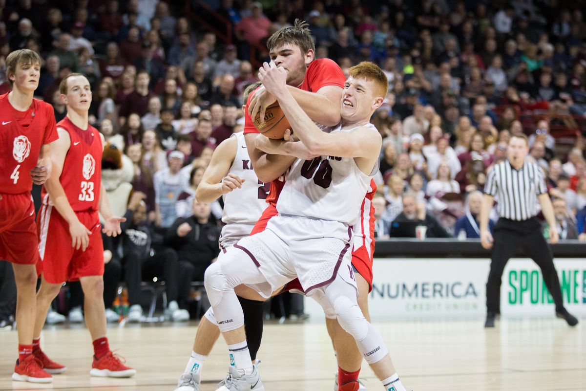 Caleb Harris (00) of Kittitas tries to gain possesion of a rebound as Conner Ashworth (50) of Brewster does the same during the semifinal of the state 2B tournament on Saturday, March 1, 2019 at the Spokane Arena. The Kittitas Coyotes beat the Brewster Bears in an exciting 77-71 win. (Libby Kamrowski / The Spokesman-Review)