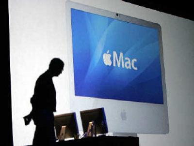 Steve Jobs with an Apple iMac powered by an Intel processor.  
 (Associated Press / The Spokesman-Review)