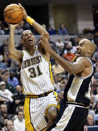 
Indiana Pacers guard Reggie Miller, left, is fouled by San Antonio's Bruce Bowen as he shoots in the fourth quarter.
 (Associated Press / The Spokesman-Review)