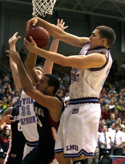 Loyola Marymount forward Drew Viney, right, takes the ball from Gonzaga’s Elias Harris.  (Associated Press)