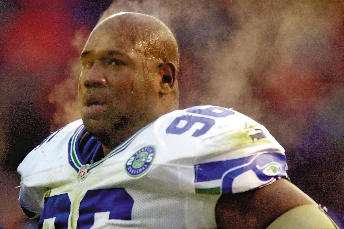 FILE- In this Sunday Dec. 10, 2000 file photo, steam rises from the body and head of Seattle Seahawks defensive tackle Cortez Kennedy as he rests on the sidelines during the third quarter of their game with the Denver Broncos at Mile High Stadium in Denver. (DAVID ZALUBOWSKI / Associated Press)