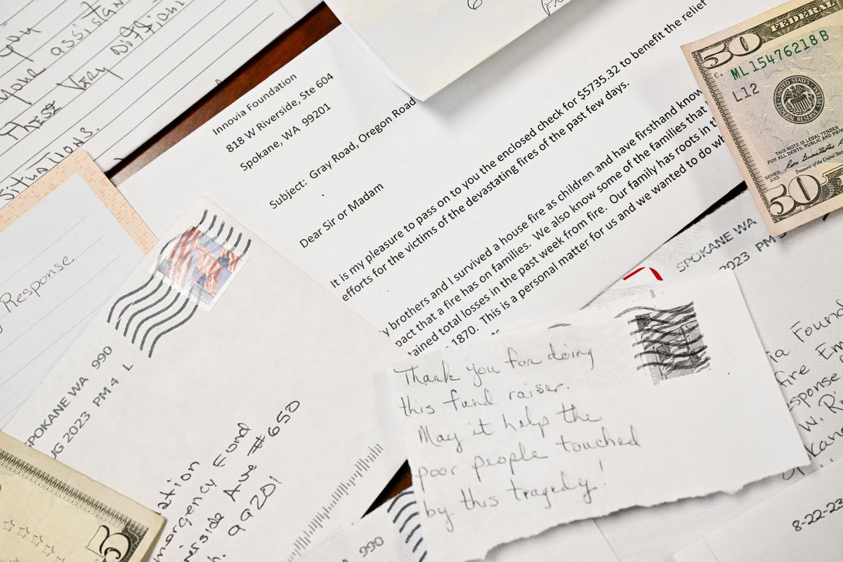 Letters included with donations for wildfire victims are photographed on Friday at the Innovia Foundation’s offices in downtown Spokane.  (Tyler Tjomsland/The Spokesman-Review)