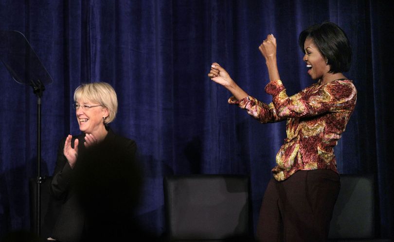 First Lady Michelle Obama, right, cheers Sen. Patty Murray at a Senate campaign fundraiser Monday, Oct. 25, 2010, in Bellevue. (Elaine Thompson / Associated Press)