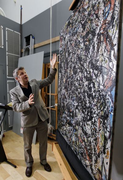 Nicholas Dorman, chief conservator for the Seattle Art Museum, talks about his ongoing restoration work of Jackson Pollock’s painting “Sea Change” on Tuesday at the museum. (Associated Press)