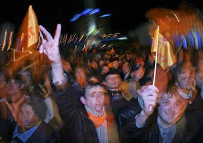 
A supporter of opposition presidential candidate Viktor Yushchenko gestures at  a mass gathering in Kiev on Sunday. 
 (Associated Press / The Spokesman-Review)
