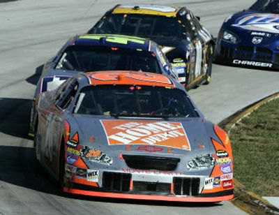
Tony Stewart (20) drives into turn four followed closely by Jimmie Johnson (48) and Joe Nemechek (01) near the end of last month's Subway 500 in Martinsville Va.
 (Associated Press / The Spokesman-Review)