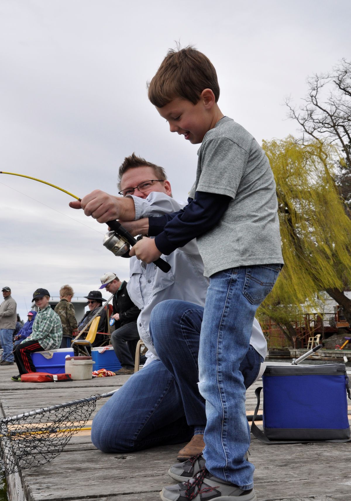 Quinn Connacher, 6, of Spokane works to catch his first trout while fishing off the dock at Bunker