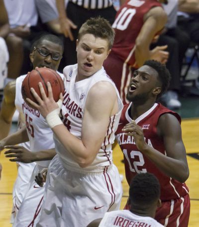 In this Dec. 22, 2015 file photo, Washington State forward Josh Hawkinson, front left, controls a rebound as Oklahoma forward Khadeem Lattin watches during the first half of the Diamond Head Classic. Hawkinson will play for the Pac-12 team this summer in Australia. (Eugene Tanner / Associated Press)
