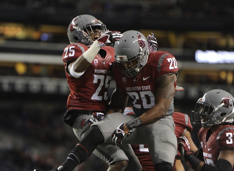 Washington State’s Daquawn Brown, left, and Deone Bucannon celebrate an interception during first-half action at CenturyLink Field in Seattle. (Tyler Tjomsland)