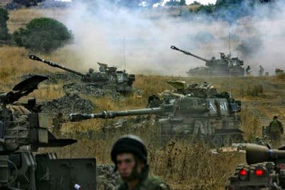
Israeli artillery fire across the border into southern Lebanon from an Israeli position along the border with Lebanon Friday
 (Photos by Associated Press / The Spokesman-Review)