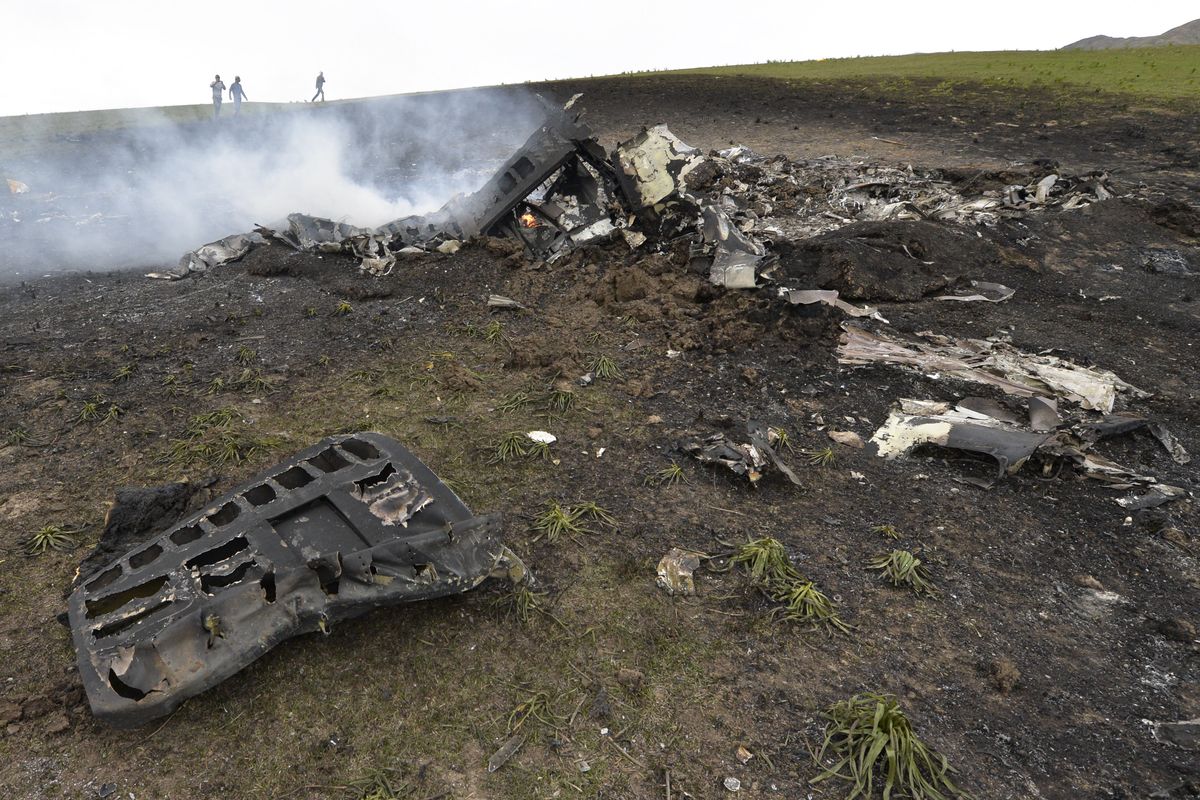 Wreckage from a U.S. Air Force KC-135 tanker aircraft is strewn across a field near the village of Chaldovar, about 100 miles west of the Kyrgyz capital Bishkek, on Friday. The plane was reportedly on a refueling mission for Afghanistan war operations at the time of the crash. (Associated Press)